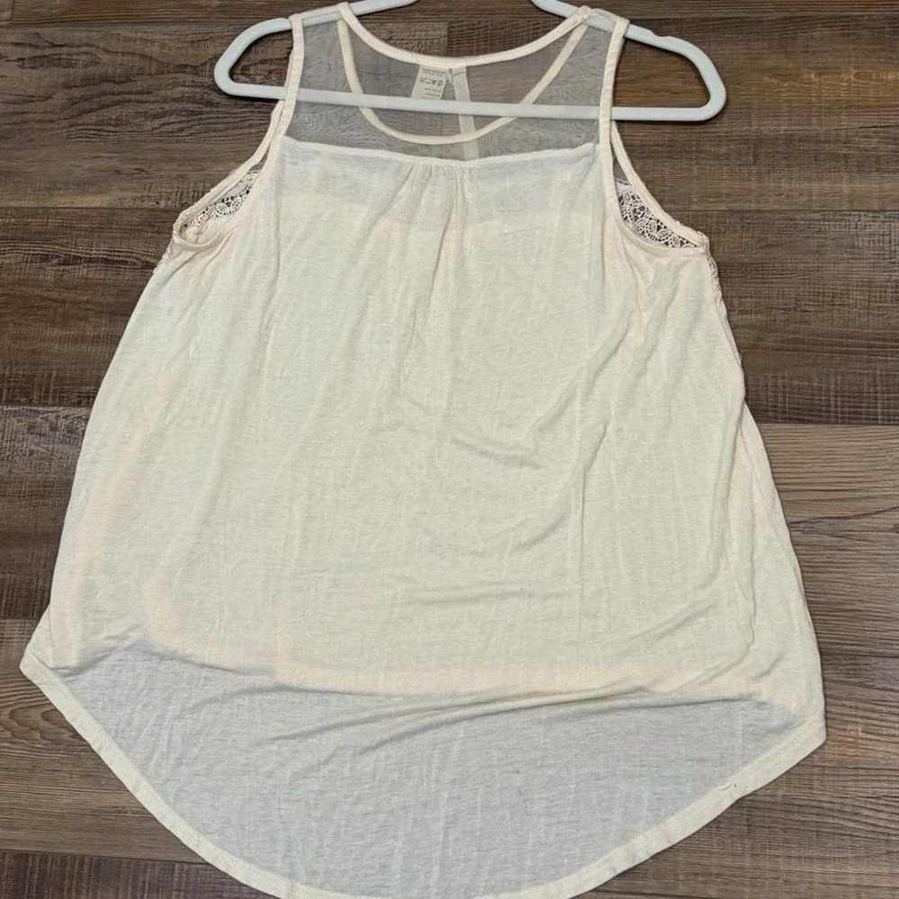 Cream lace tank top with sheer mesh and lace trim on the shoulders